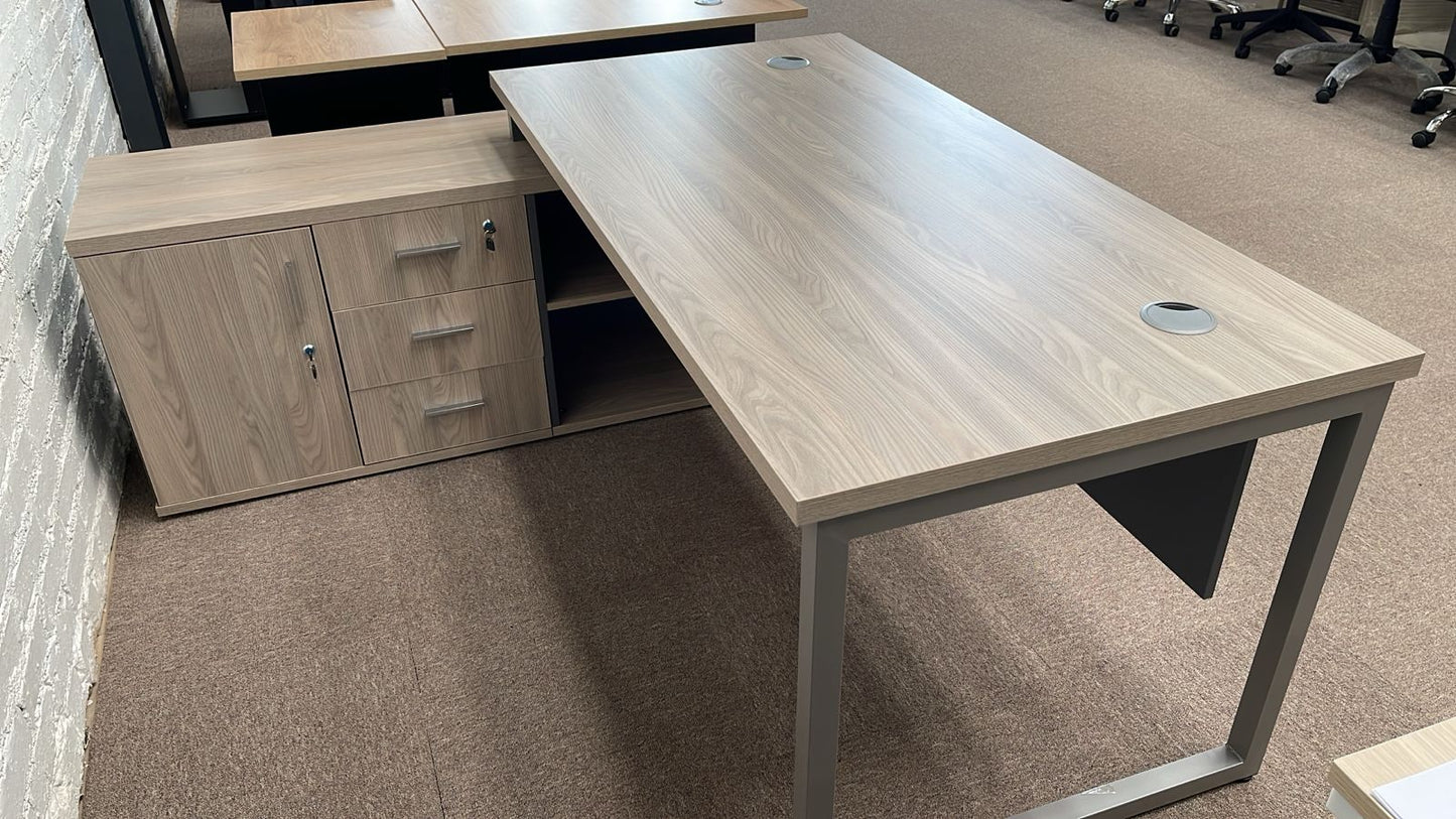 A modern, Titan Executive Desk featuring a sleek 32mm top, integrated storage units on one side, and a modesty panel.