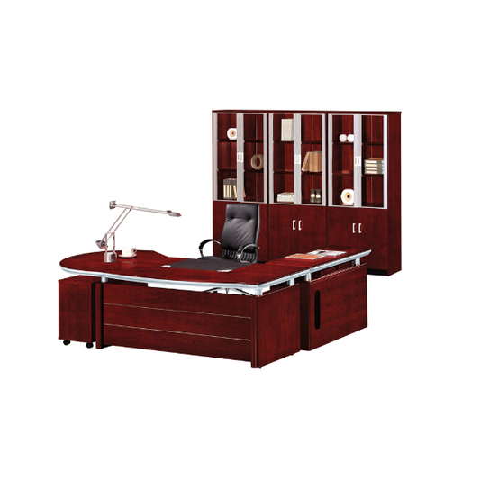 Modern executive office setup with a large L-shaped dark reddish-brown wooden desk, topped with a metallic desk lamp, pen holder, and neatly arranged documents. A black leather office chair sits at the desk, while a matching wooden cabinet with glass doors behind it displays books and decorative items, creating a professional and elegant workspace.