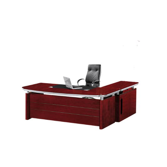Modern executive office desk made of dark reddish-brown wood with metallic accents, featuring a black leather desk mat, an open silver laptop, and a black leather office chair with armrests behind it. The desk has a large main surface and a side extension, creating a sleek professional workspace.